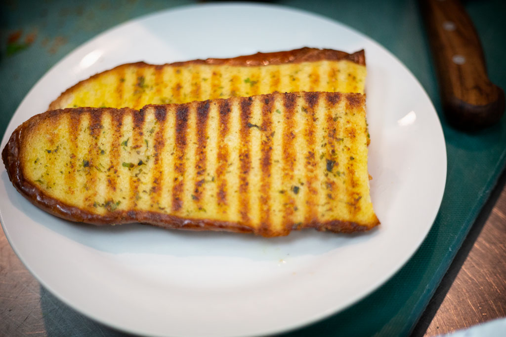 Grilled sliced bread brushed with garlic & herb oil